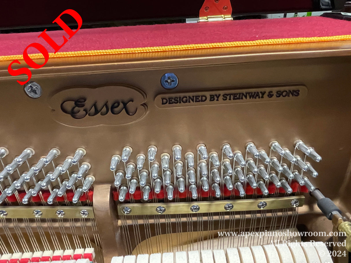 Interior view of an Essex piano designed by Steinway & Sons, showing detailed craftsmanship of the hammer mechanism.