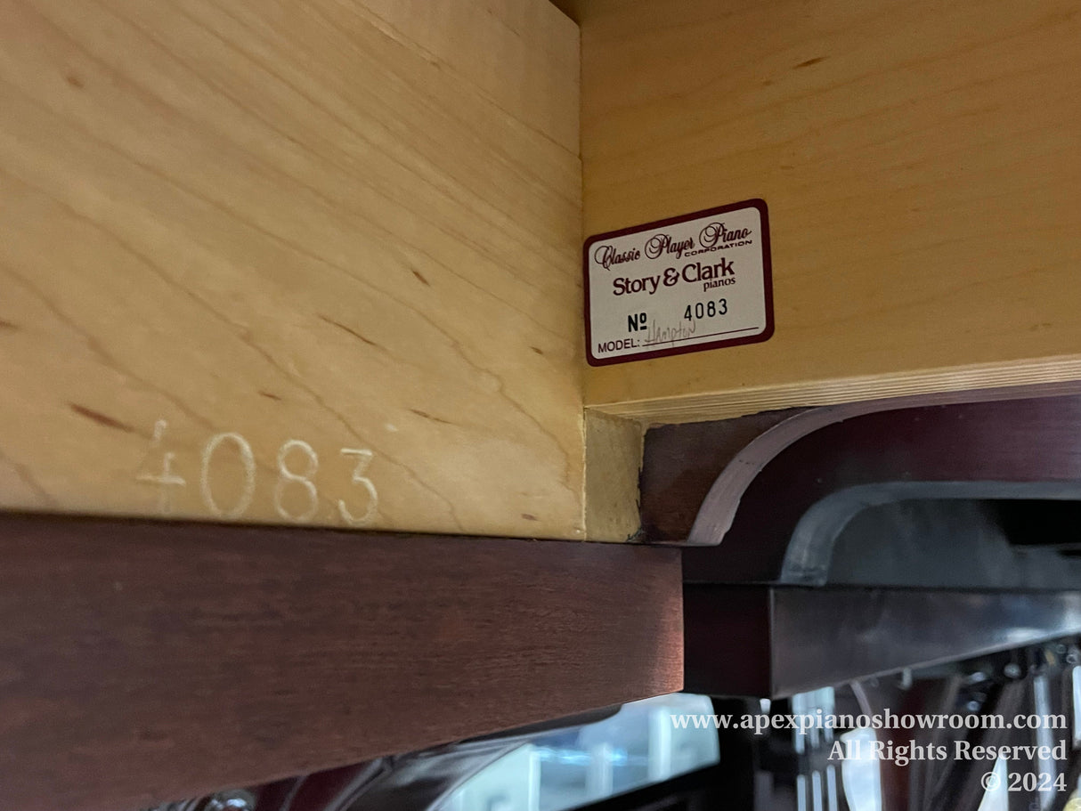 Close-up view of a Story & Clark classic player piano identification plate with the serial number 4083, indicating model and brand details within a wooden piano interior.