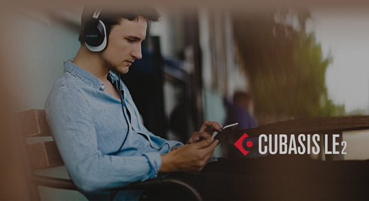 A person using headphones while interacting with a music production app on a smartphone, potentially for piano sound editing or composition using Cubasis LE2 software.