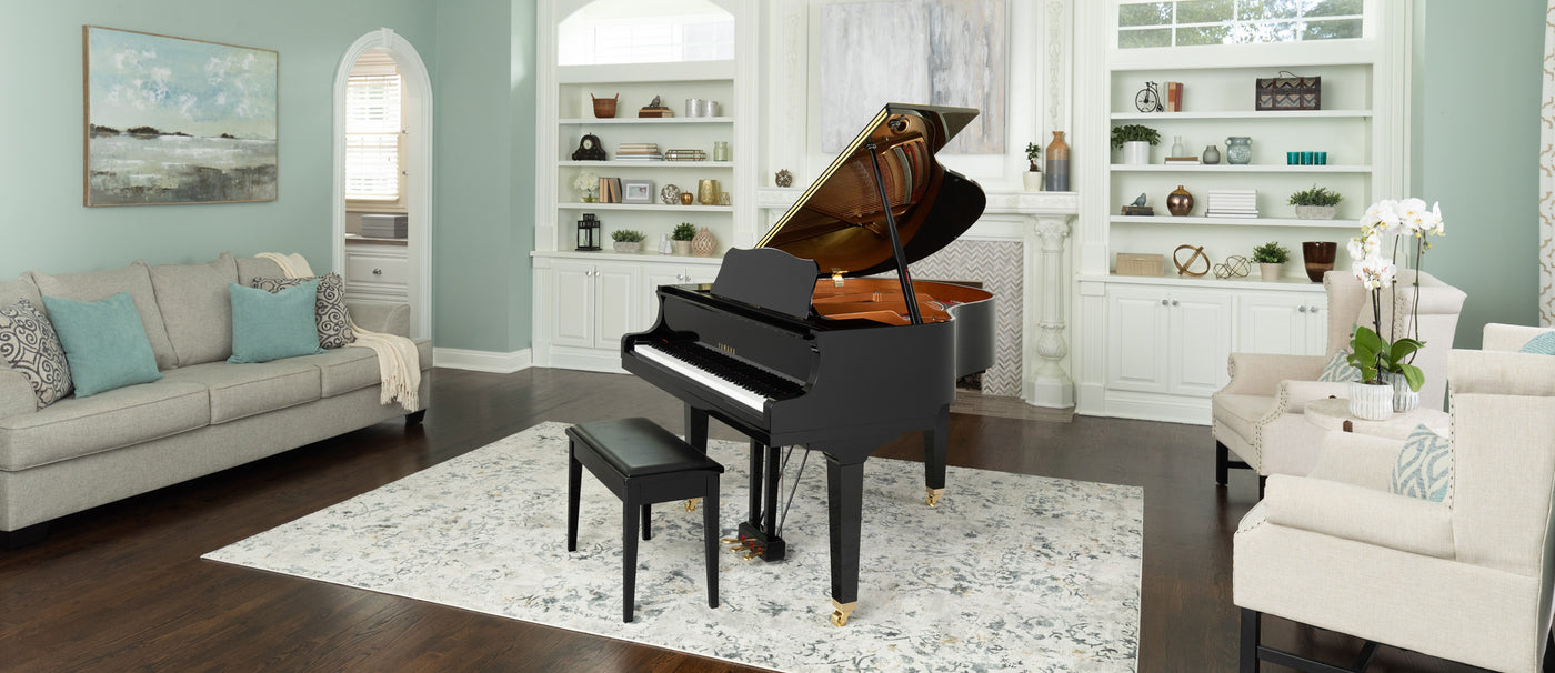 side view of polished ebony yamaha grand piano gb1k featured in homepage hero section