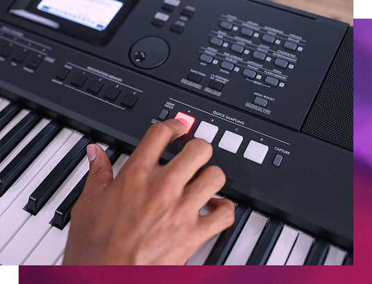 Person pressing a button on a digital piano to initiate a loop or recording sequence.